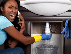 Emergency plumbing repair for a leaking sink drain under a bathroom vanity in Cleveland, OH