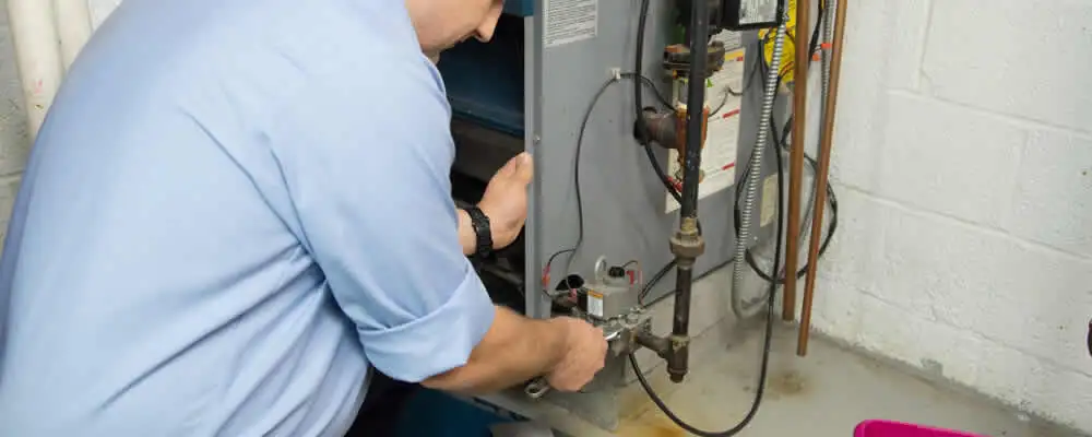 Furnace repair technician inspecting and servicing a home heating system in Cleveland, OH