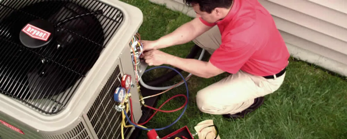 HVAC technician servicing an outdoor air conditioner unit in Cleveland, OH